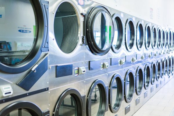 Industrial washing machines in a public laundromat.